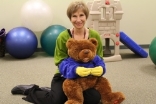 elderly woman holding teddy bear